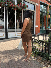 Woman wearing espresso brown suede short with matching vest top.