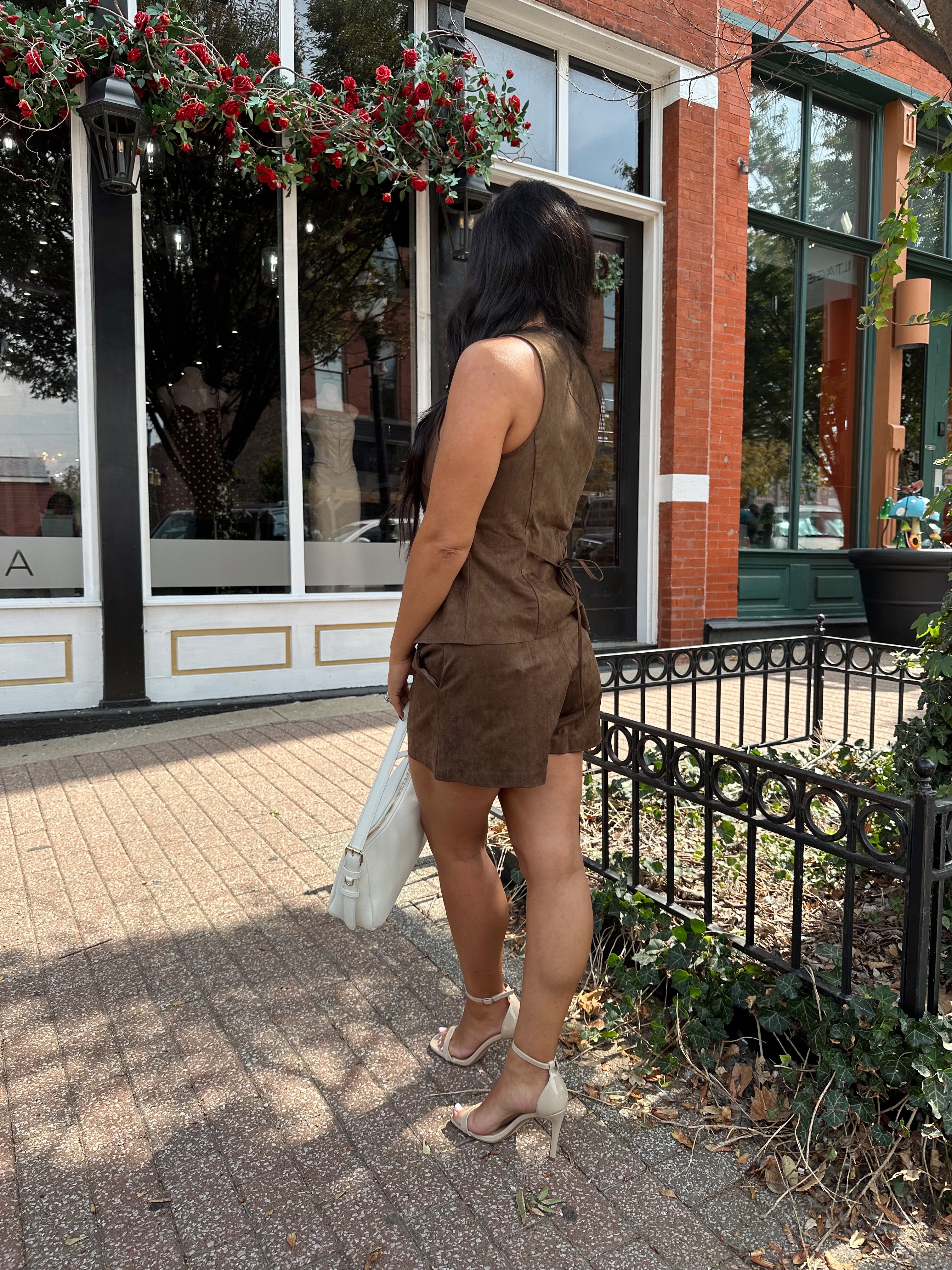 Woman wearing espresso brown suede short with matching vest top.