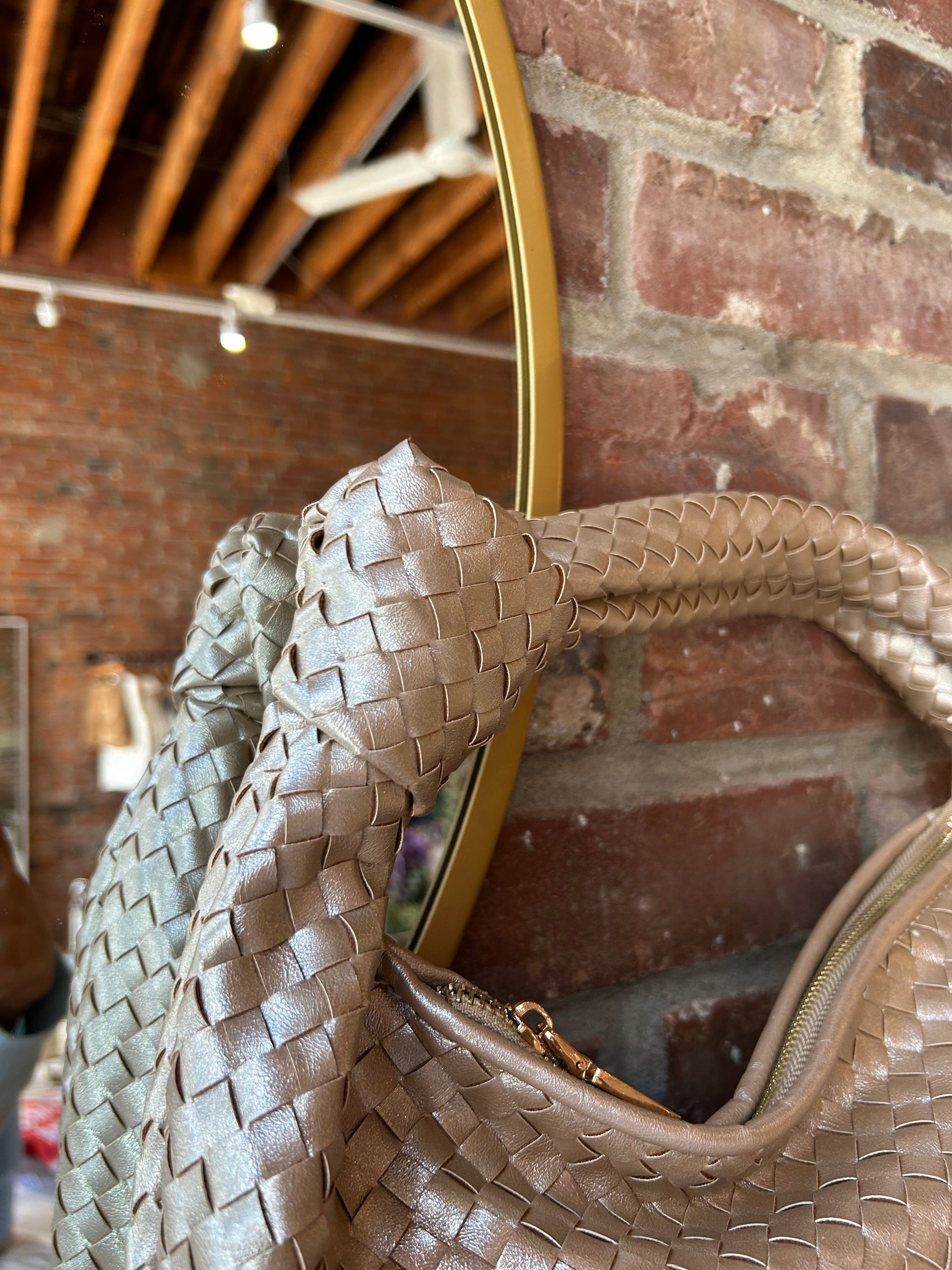Champagne color woven shoulder bag with gold hardware and knits detail. 