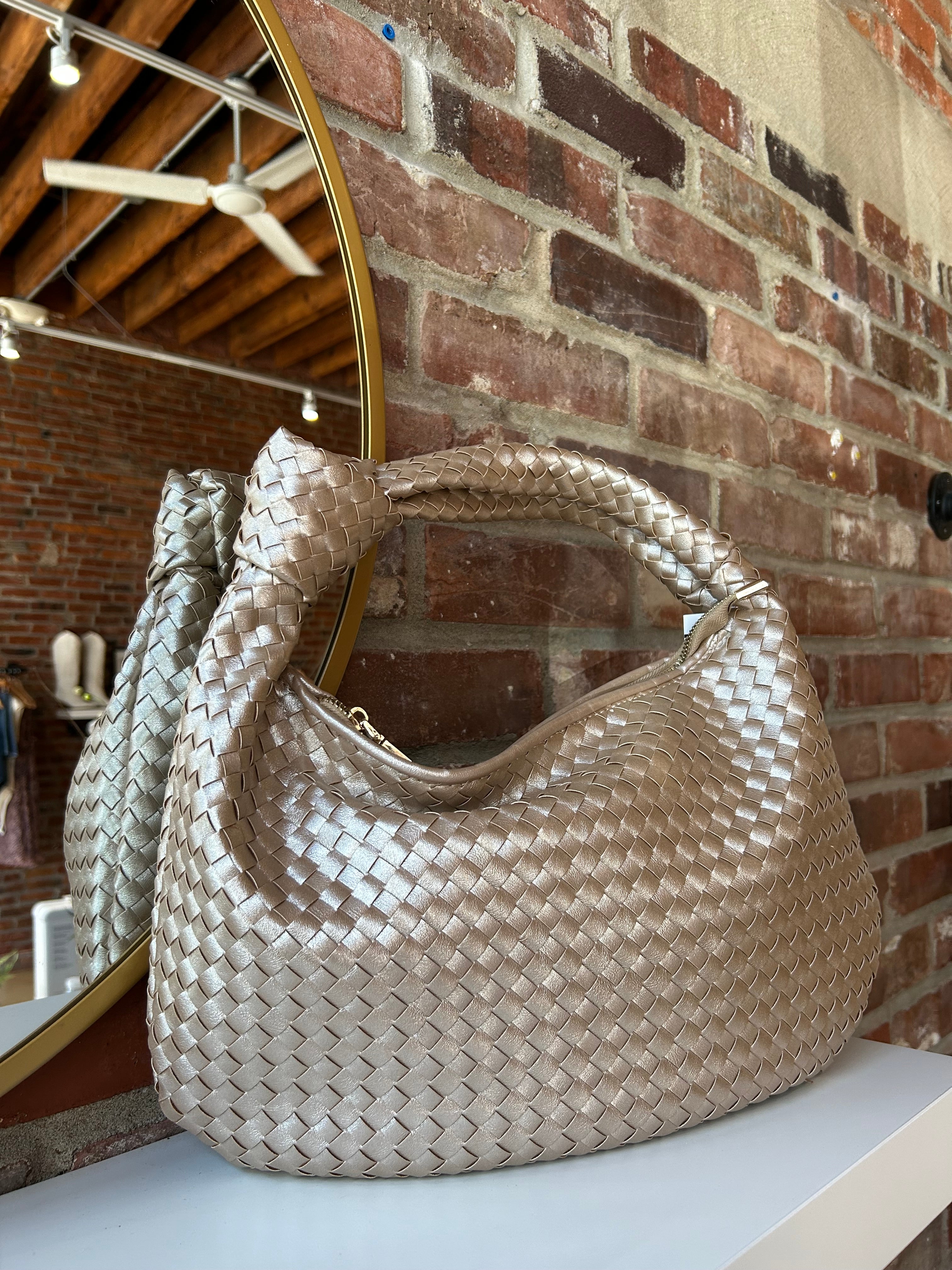 Champagne color woven shoulder bag with gold hardware and knits detail. 