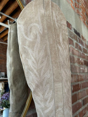 Tan suede tall Western boot with embroidered stitching, pointed toe, and stacked block heel
