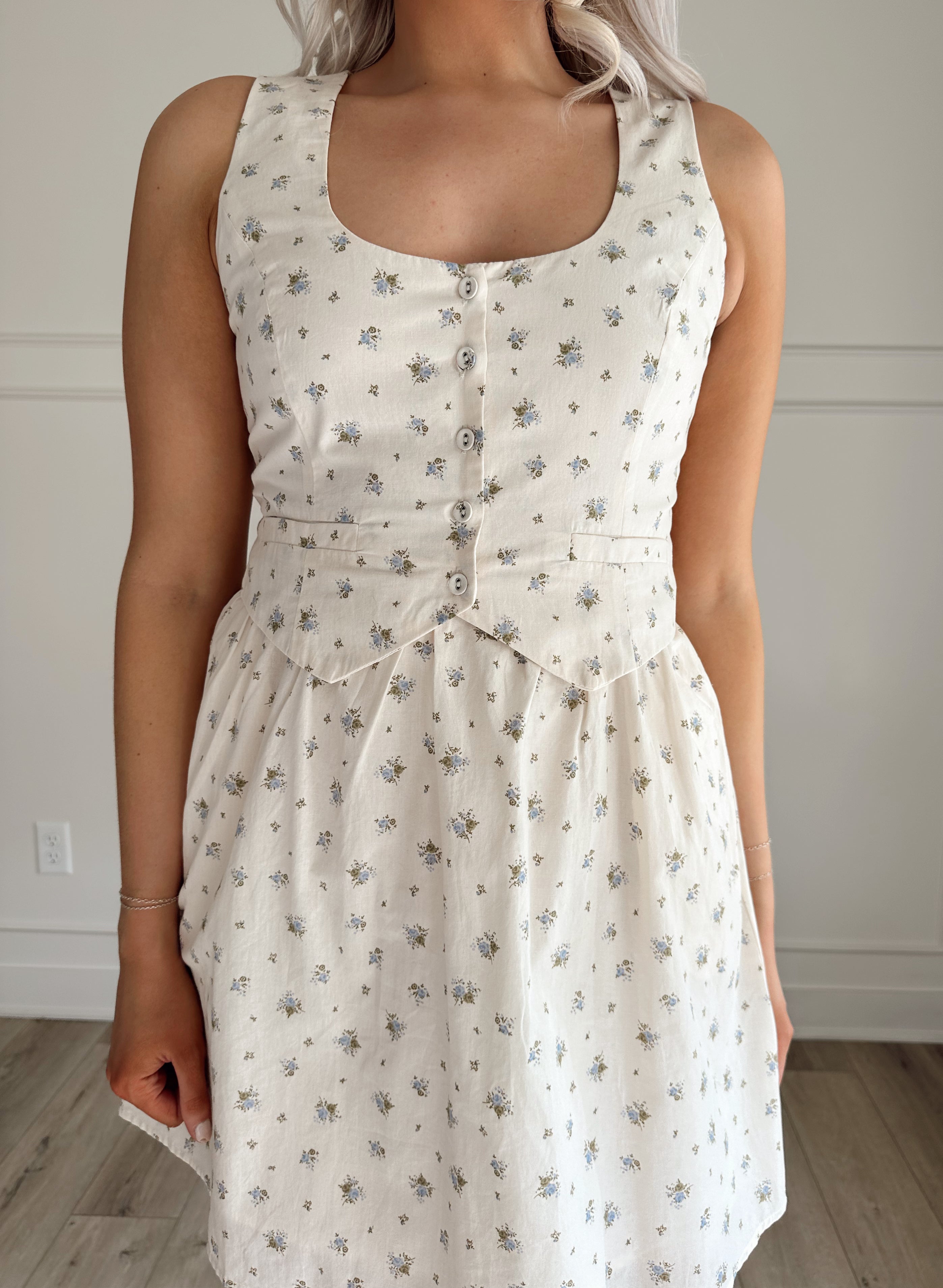 Floral babydoll mini dress with a button-up front and fitted waist.
