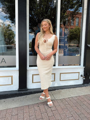 Ivory colored ribbed midi dress with cutout detail.