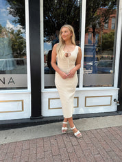 Ivory colored ribbed midi dress with cutout detail.