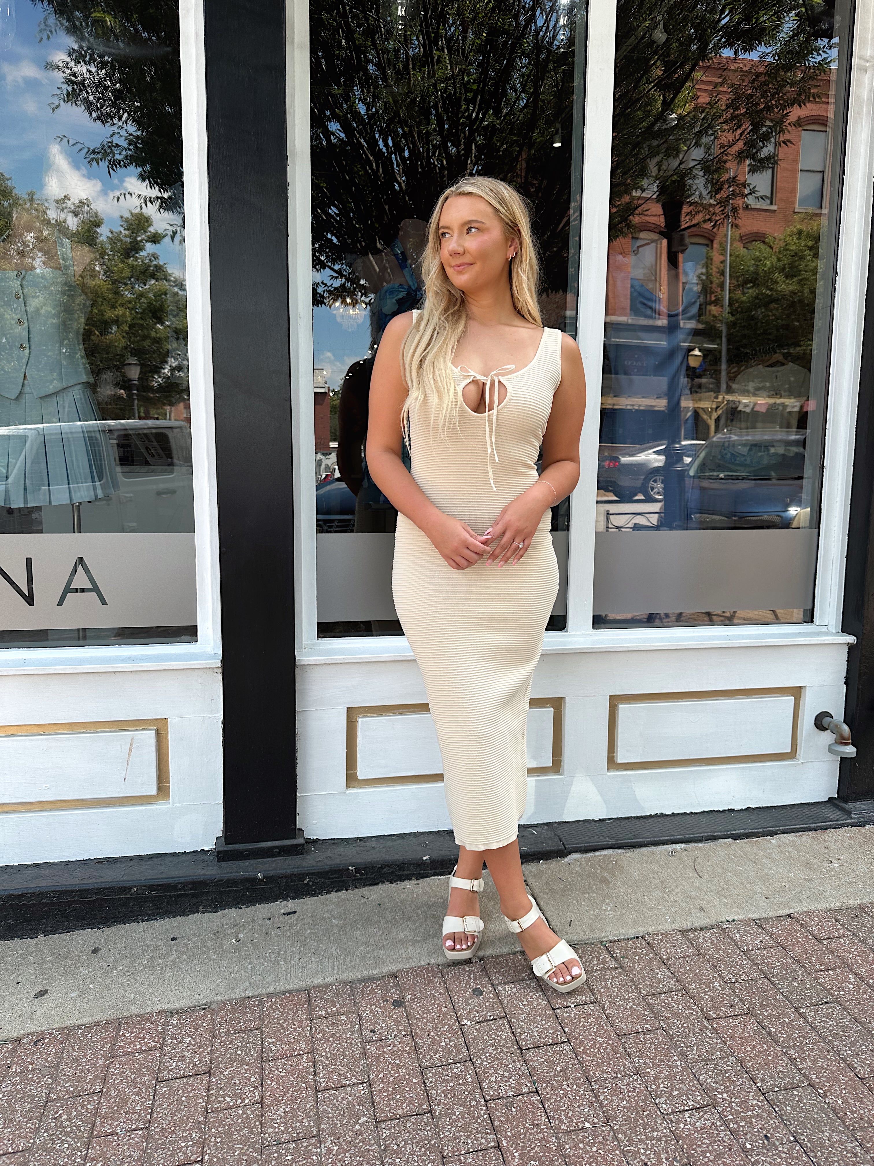 Ivory colored ribbed midi dress with cutout detail.