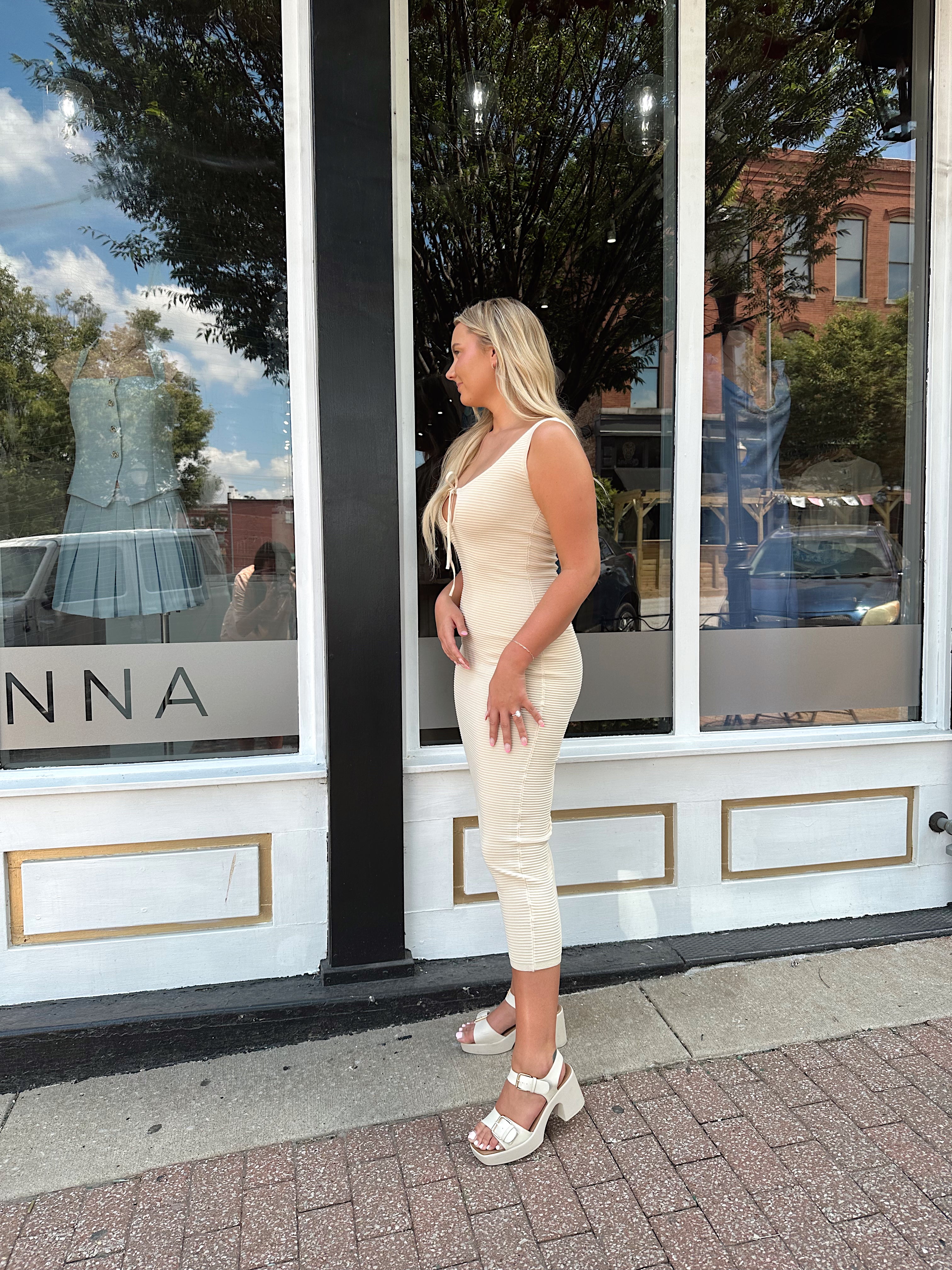 Ivory colored ribbed midi dress with cutout detail.