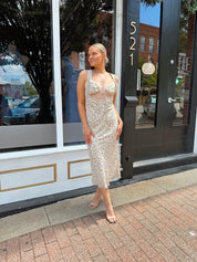 Beige floral satin midi dress with lace trim and cutout detail.