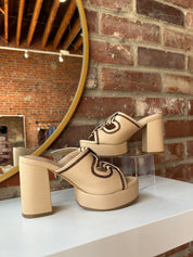 Tan platform heel with dark brown stitching and bow detail.