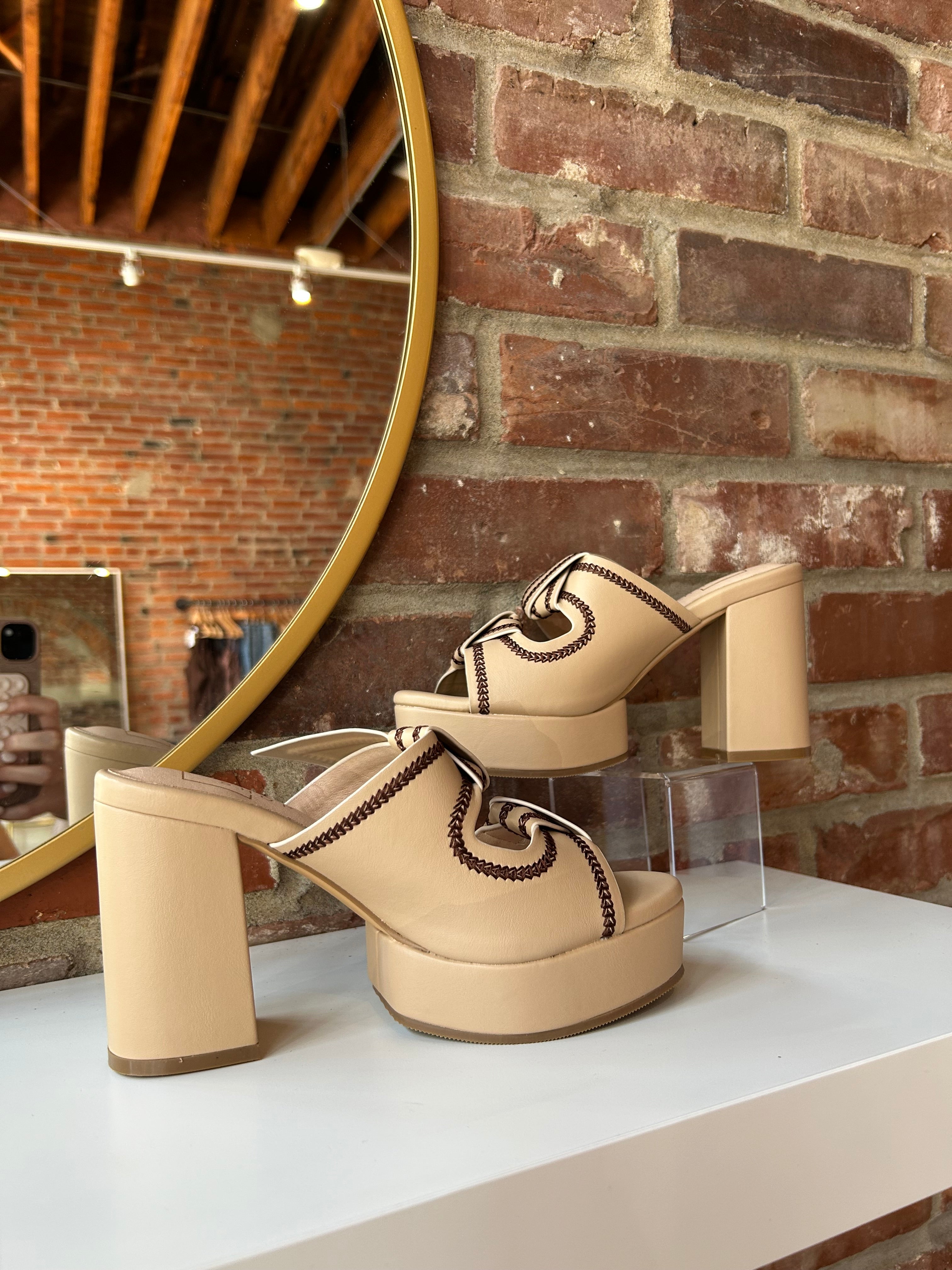 Tan platform heel with dark brown stitching and bow detail.