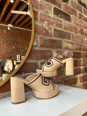 Tan platform heel with dark brown stitching and bow detail.
