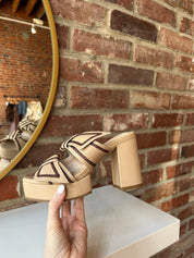 Tan platform heel with dark brown stitching and bow detail.