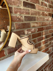 Tan platform heel with dark brown stitching and bow detail.
