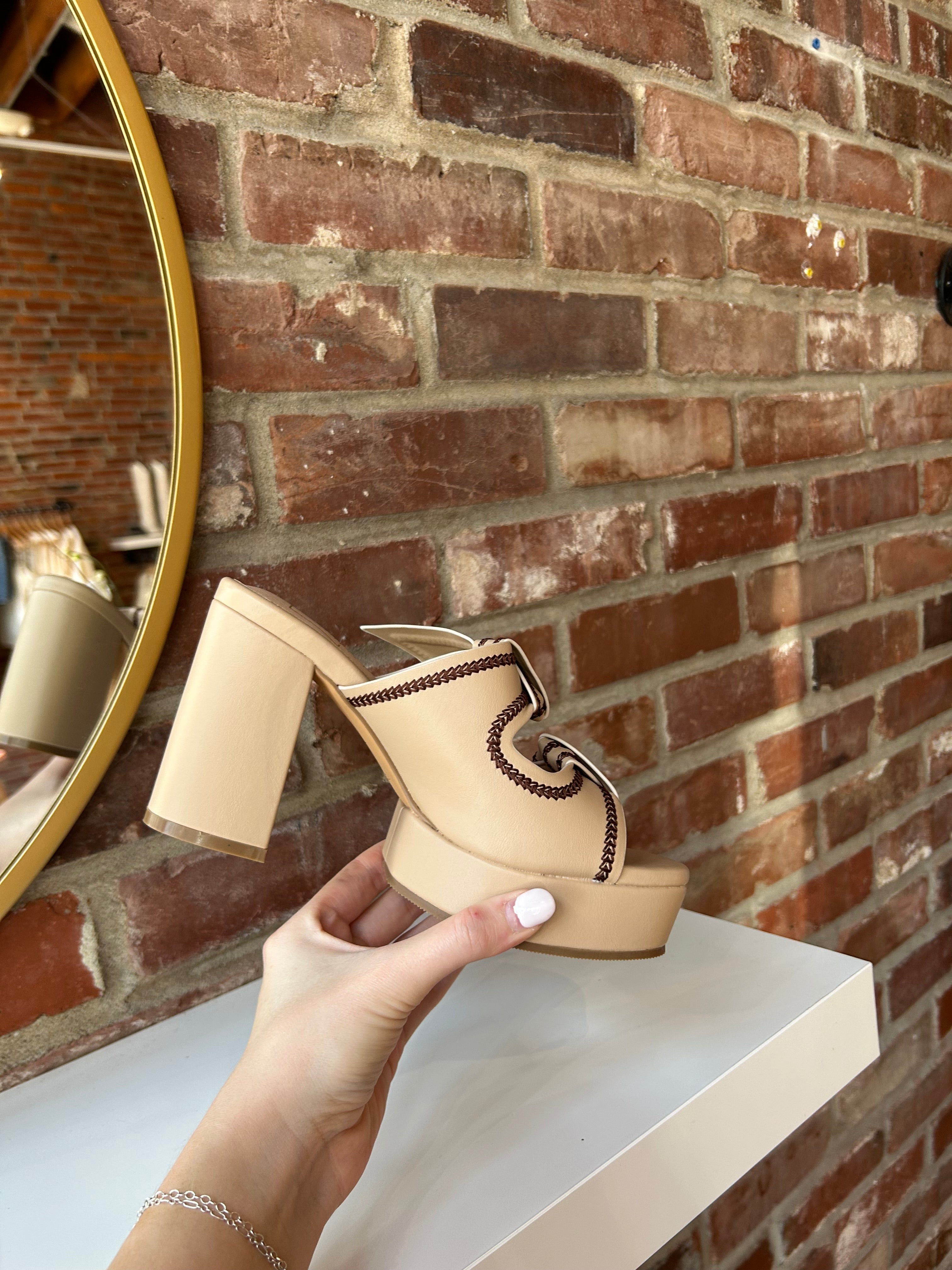 Tan platform heel with dark brown stitching and bow detail.