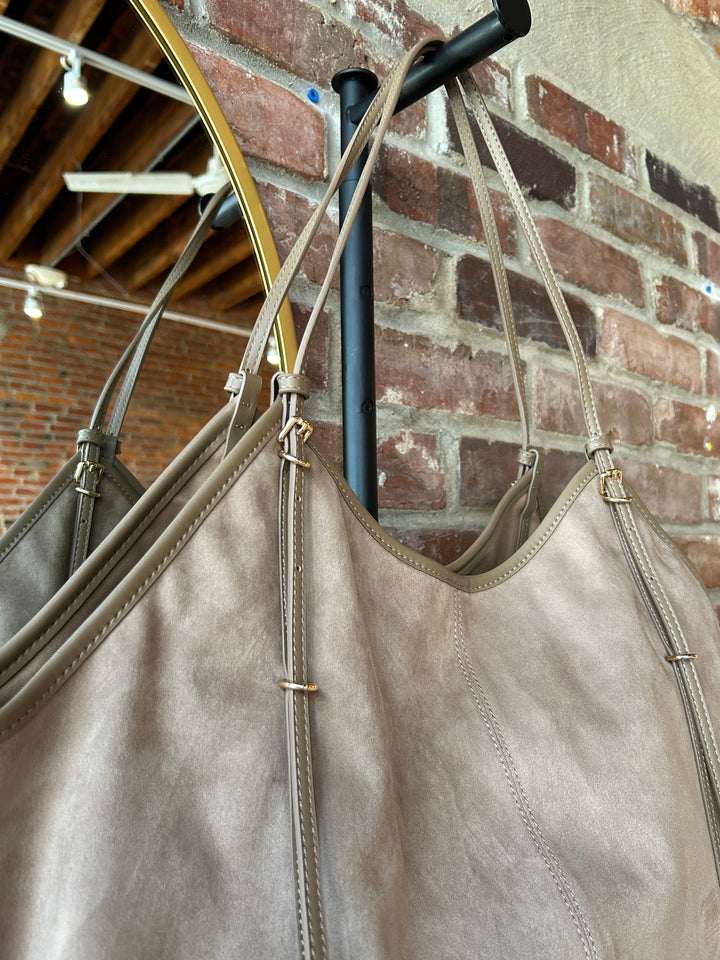 Beige suede oversized shoulder tote bag with adjustable shoulder straps. 