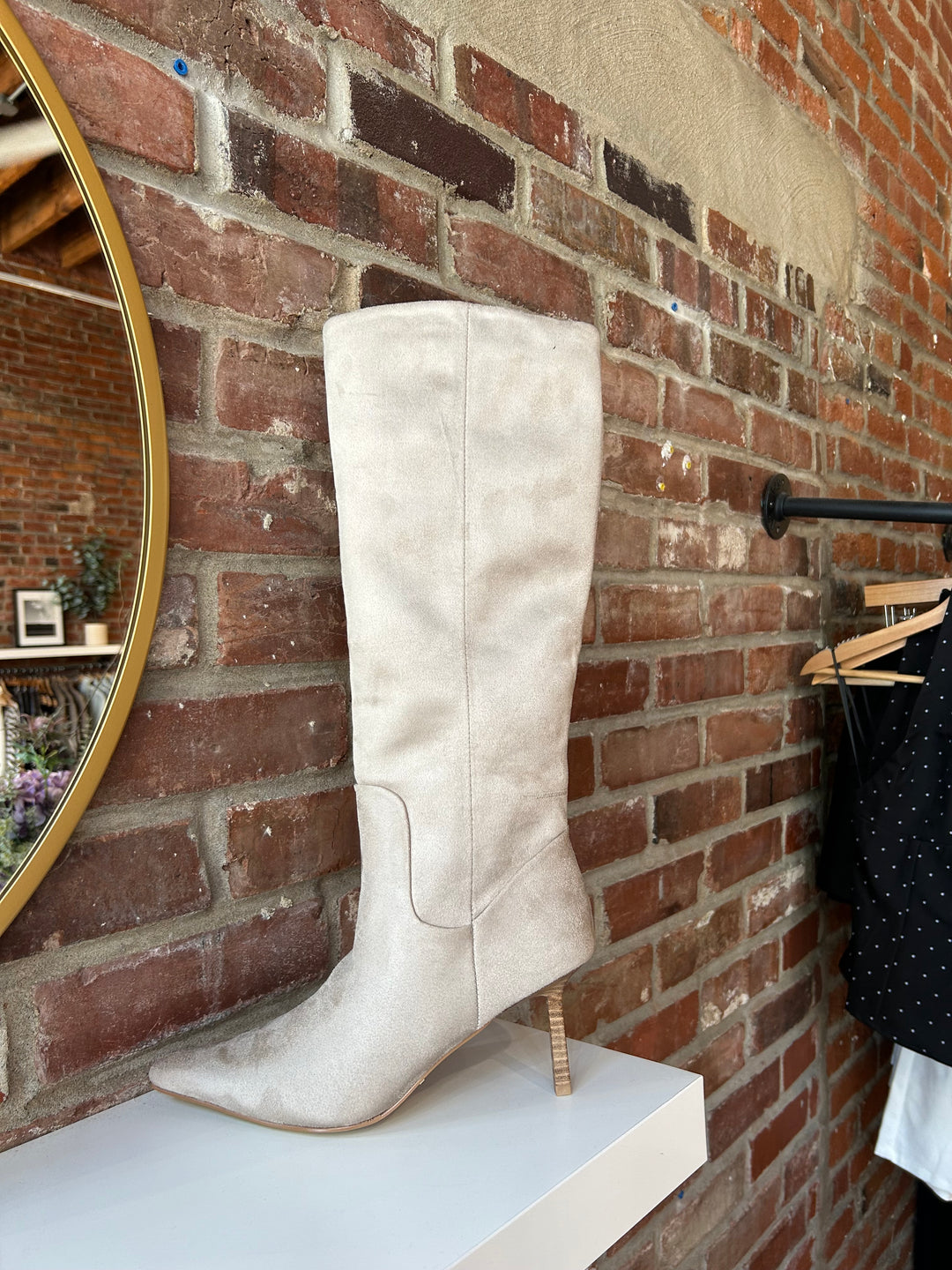 Oat colored suede tall knee boot with inner zip closure and stiletto heel.