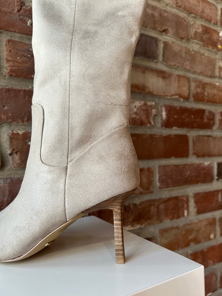 Oat colored suede tall knee boot with inner zip closure and stiletto heel.