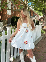 Ivory mini dress with multicolor embroidered flowers.