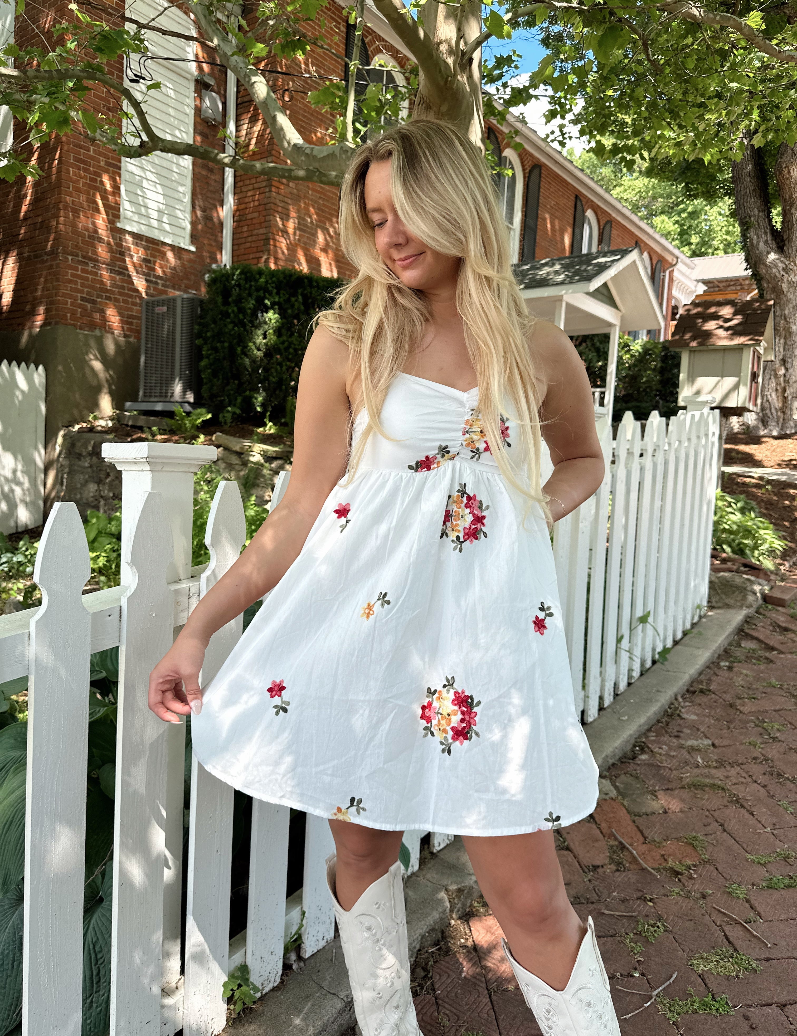 Ivory mini dress with multicolor embroidered flowers.