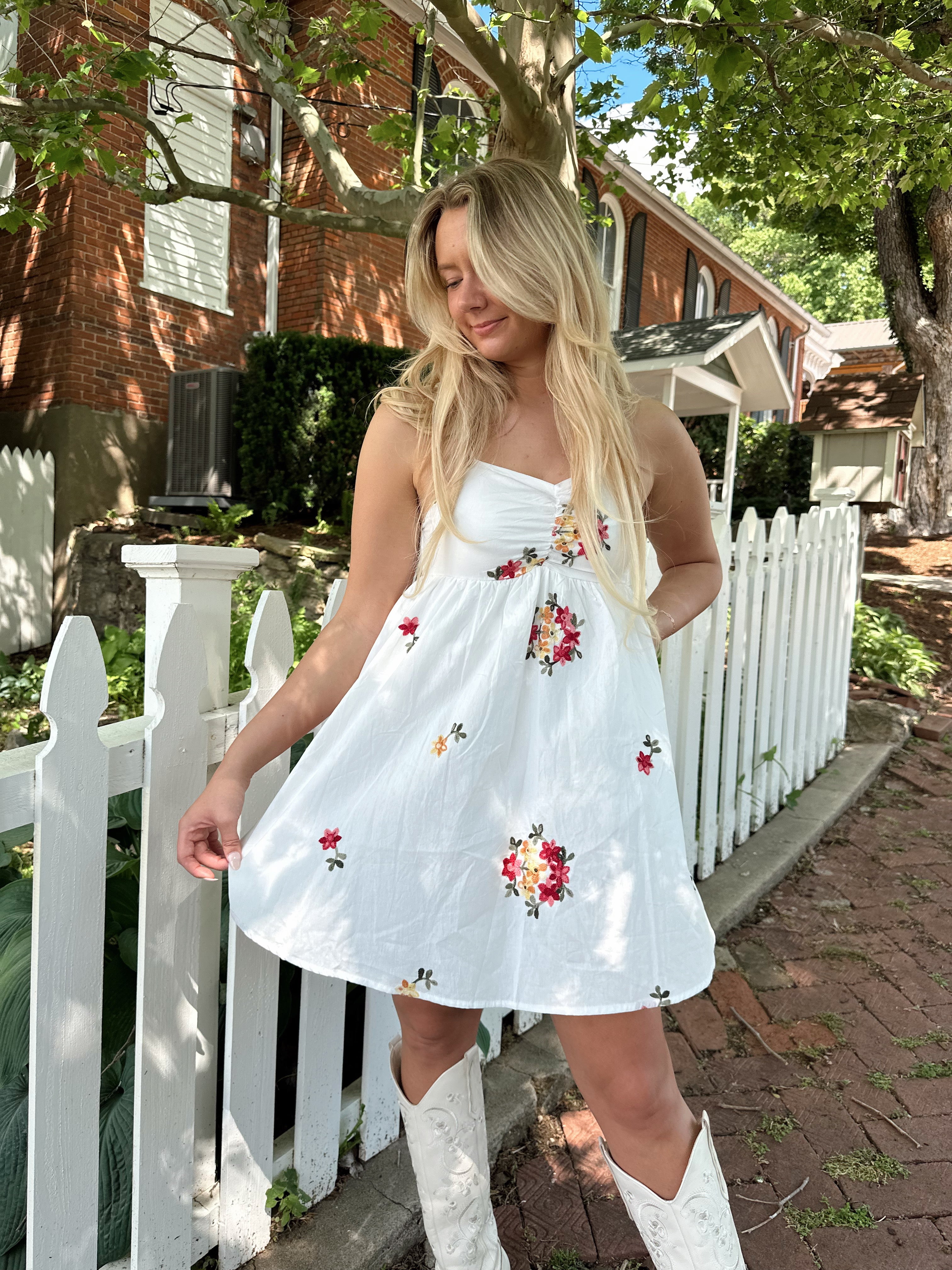 Ivory mini dress with multicolor embroidered flowers.