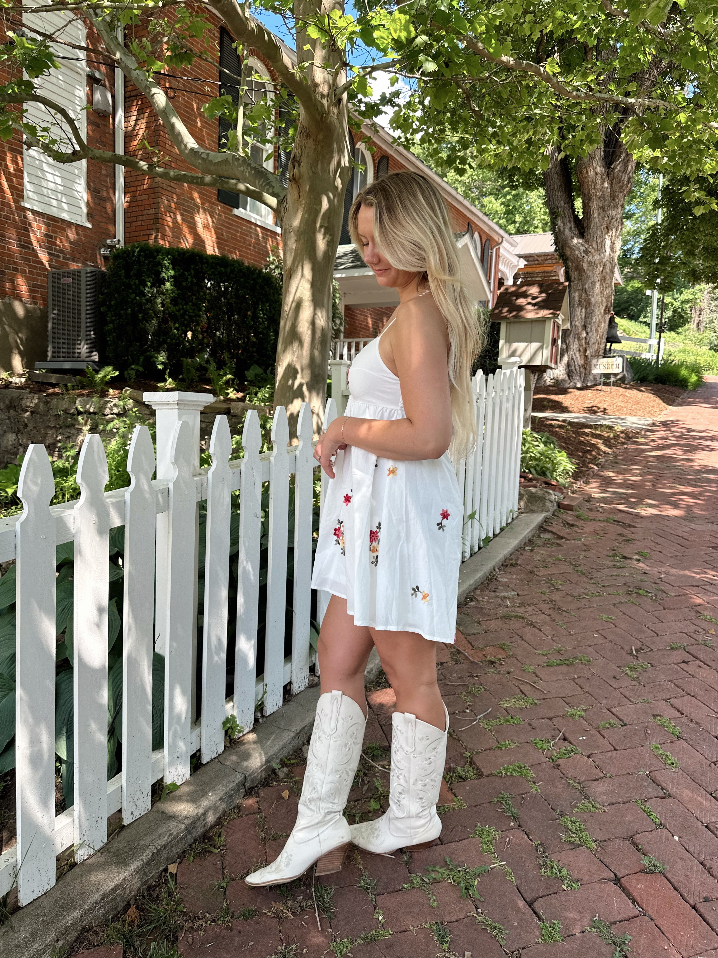 Ivory mini dress with multicolor embroidered flowers.