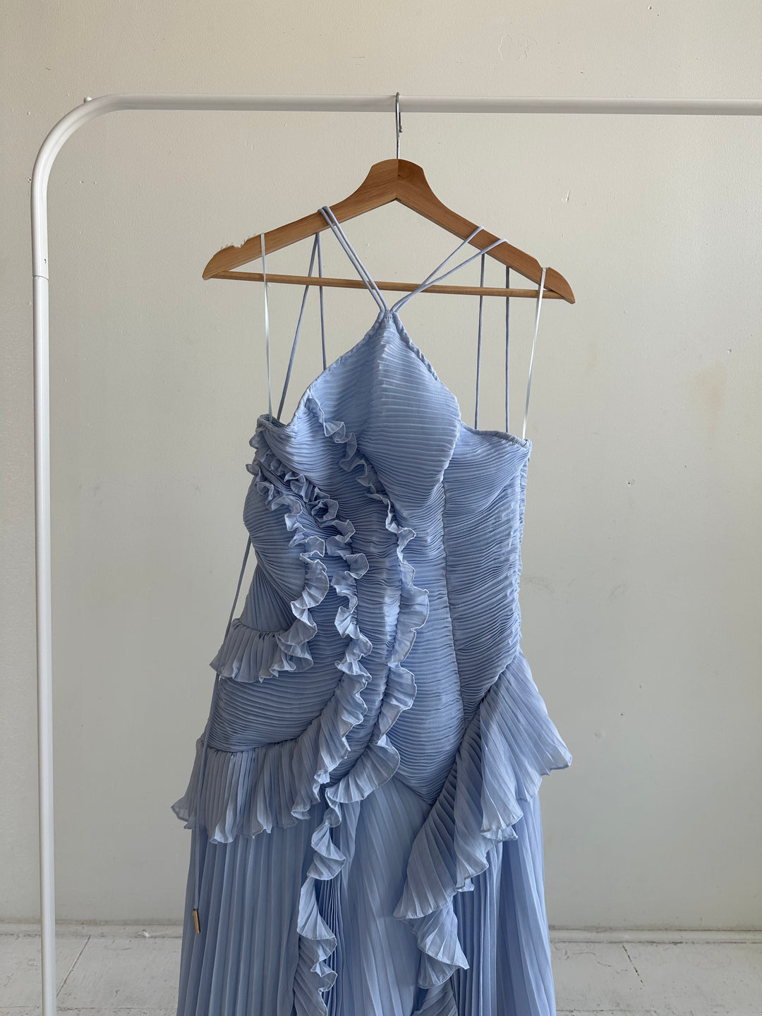 Blue chiffon textured midi dress with halter neckline.