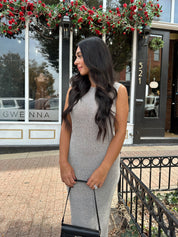 Woman wearing grey knit high neck maxi dress. Plenty of stretch. 