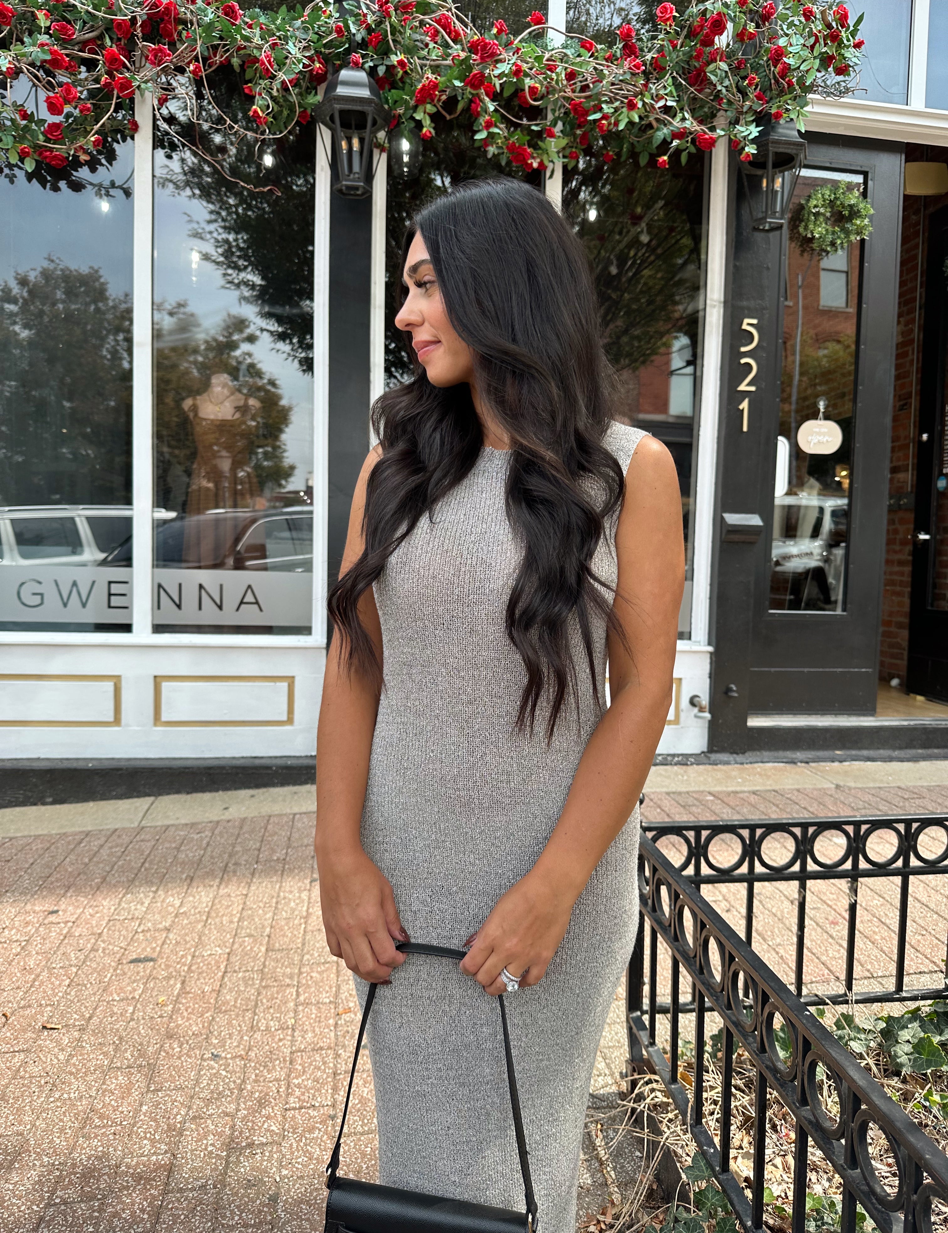 Woman wearing grey knit high neck maxi dress. Plenty of stretch. 