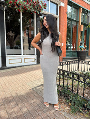 Woman wearing grey knit high neck maxi dress. Plenty of stretch. 