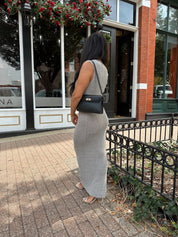 Woman wearing grey knit high neck maxi dress. Plenty of stretch. 