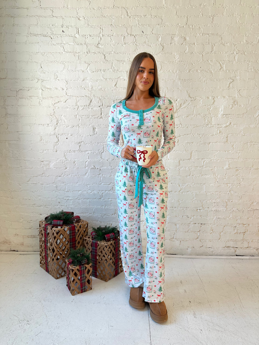 Woman wearing vintage Christmas postage pattern pajama set. 