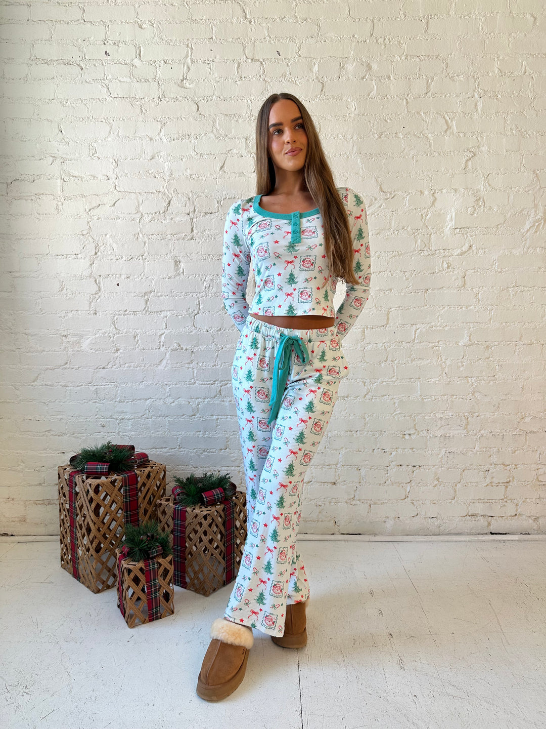 Woman wearing vintage Christmas postage pattern pajama set. 