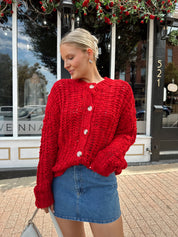 Red chunky knit cardigan with tortoise shell buttons. 