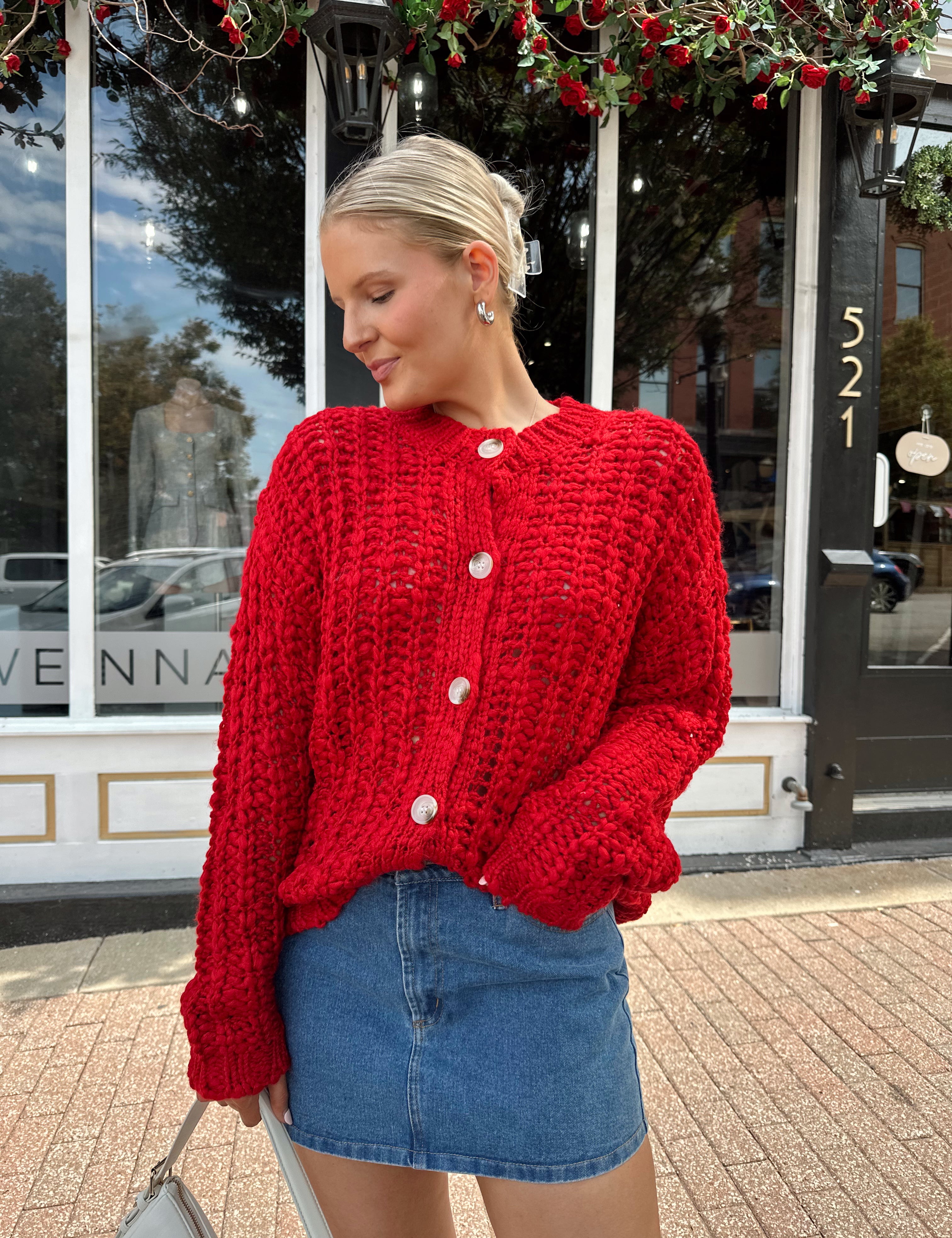 Red chunky knit cardigan with tortoise shell buttons. 