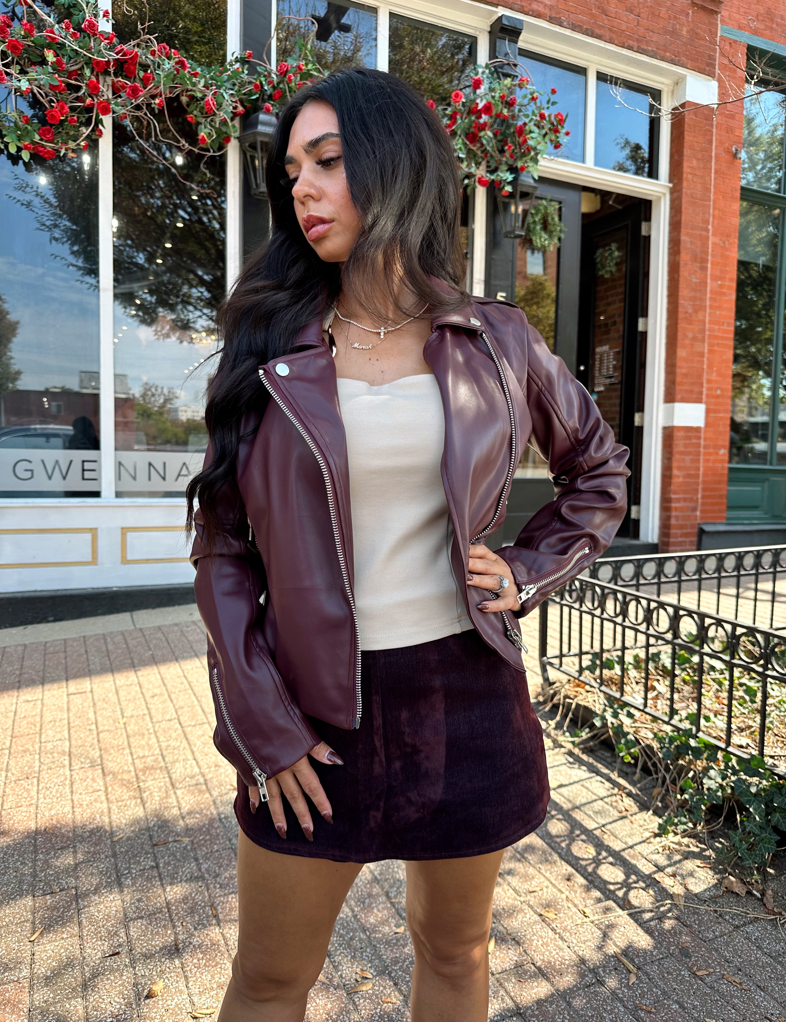 Woman wearing high waisted burgundy brushed denim mini skort. 