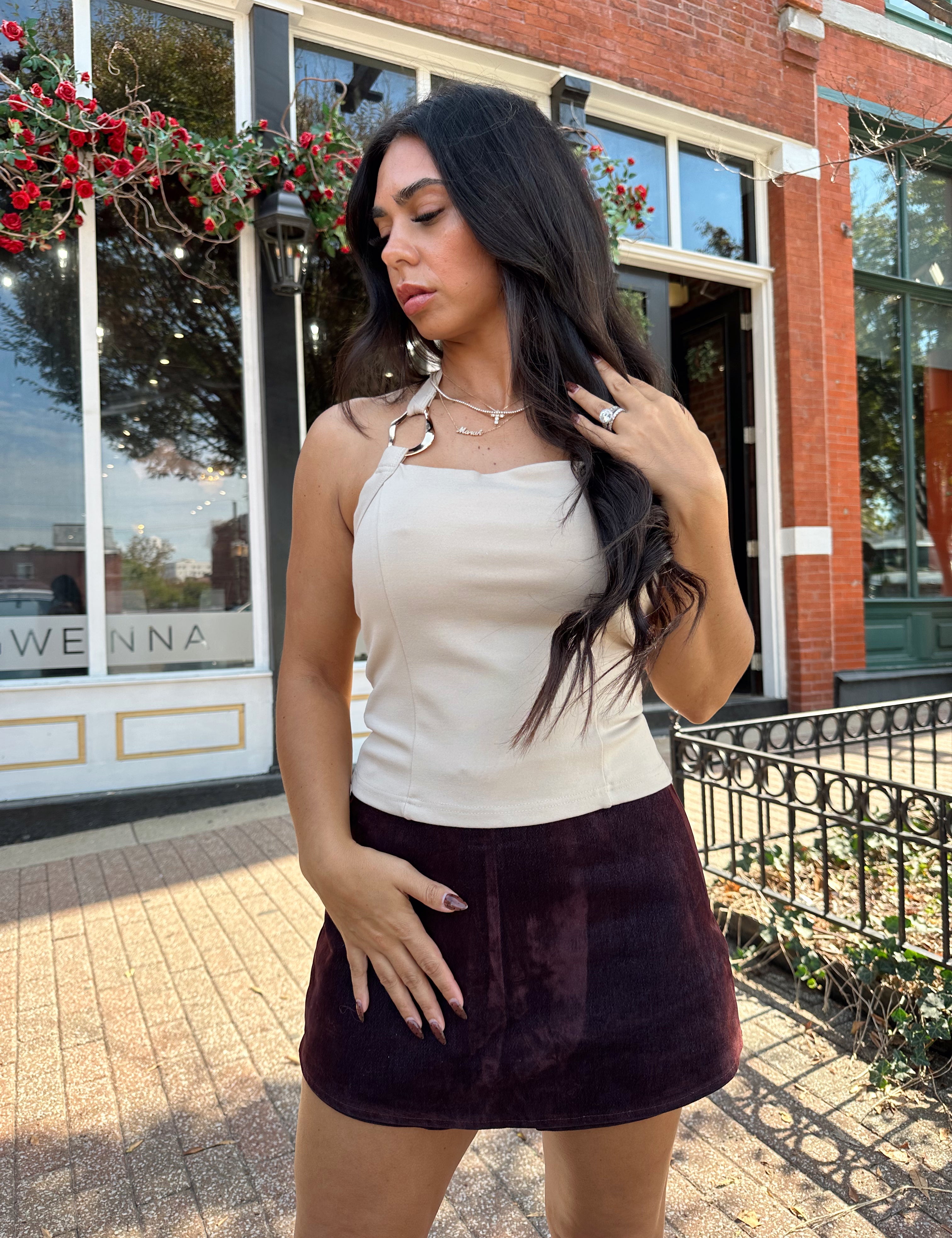 Woman wearing high waisted burgundy brushed denim mini skort. 