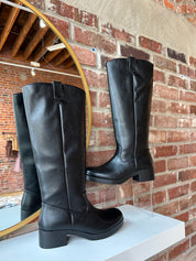 Black knee-high boots with block heel.