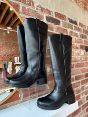 Black knee-high boots with block heel.