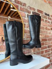 Black knee-high boots with block heel.