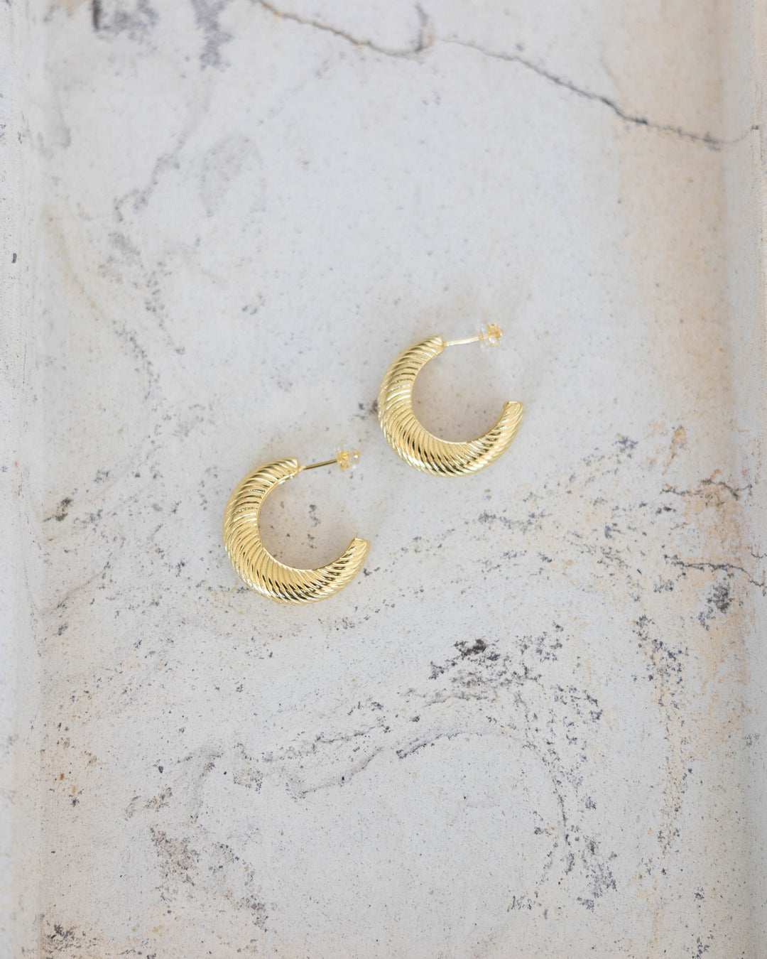 Gold plated textured gold hoop earring. 