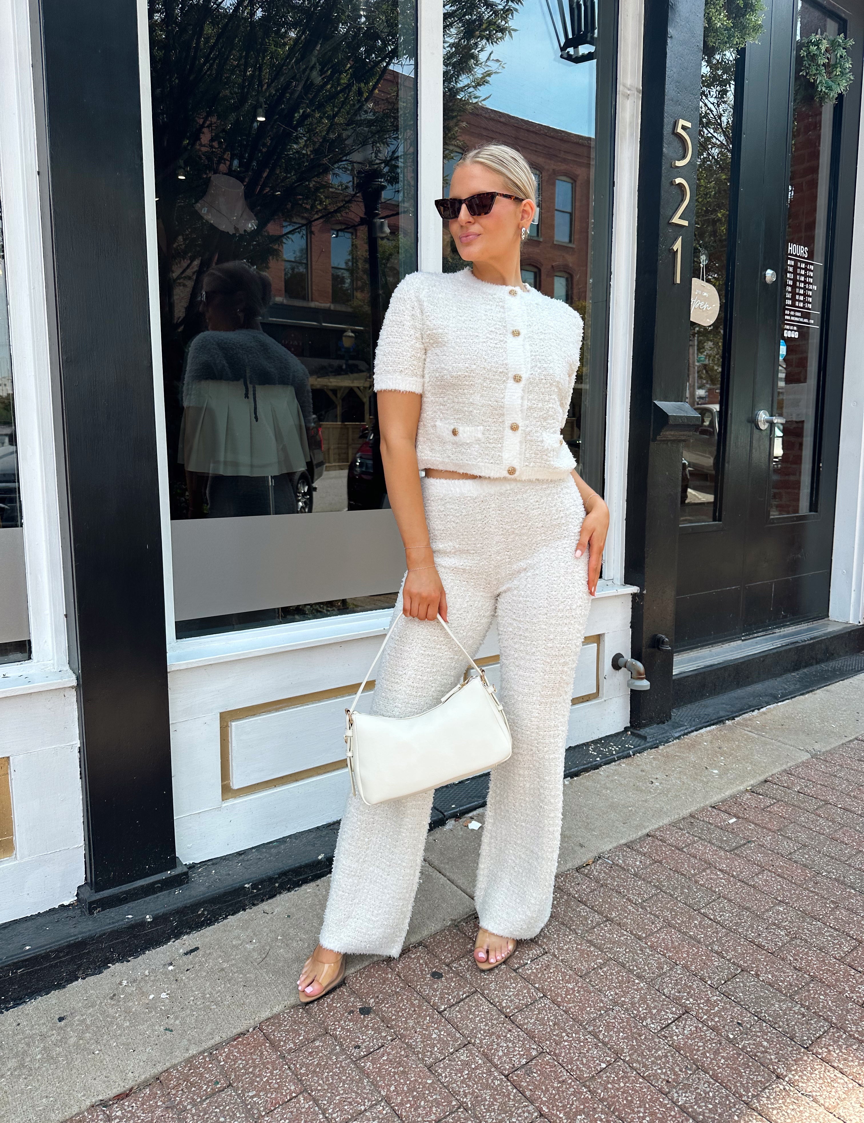 Ivory bouclé two piece set with gold button closure and wide leg pant. 