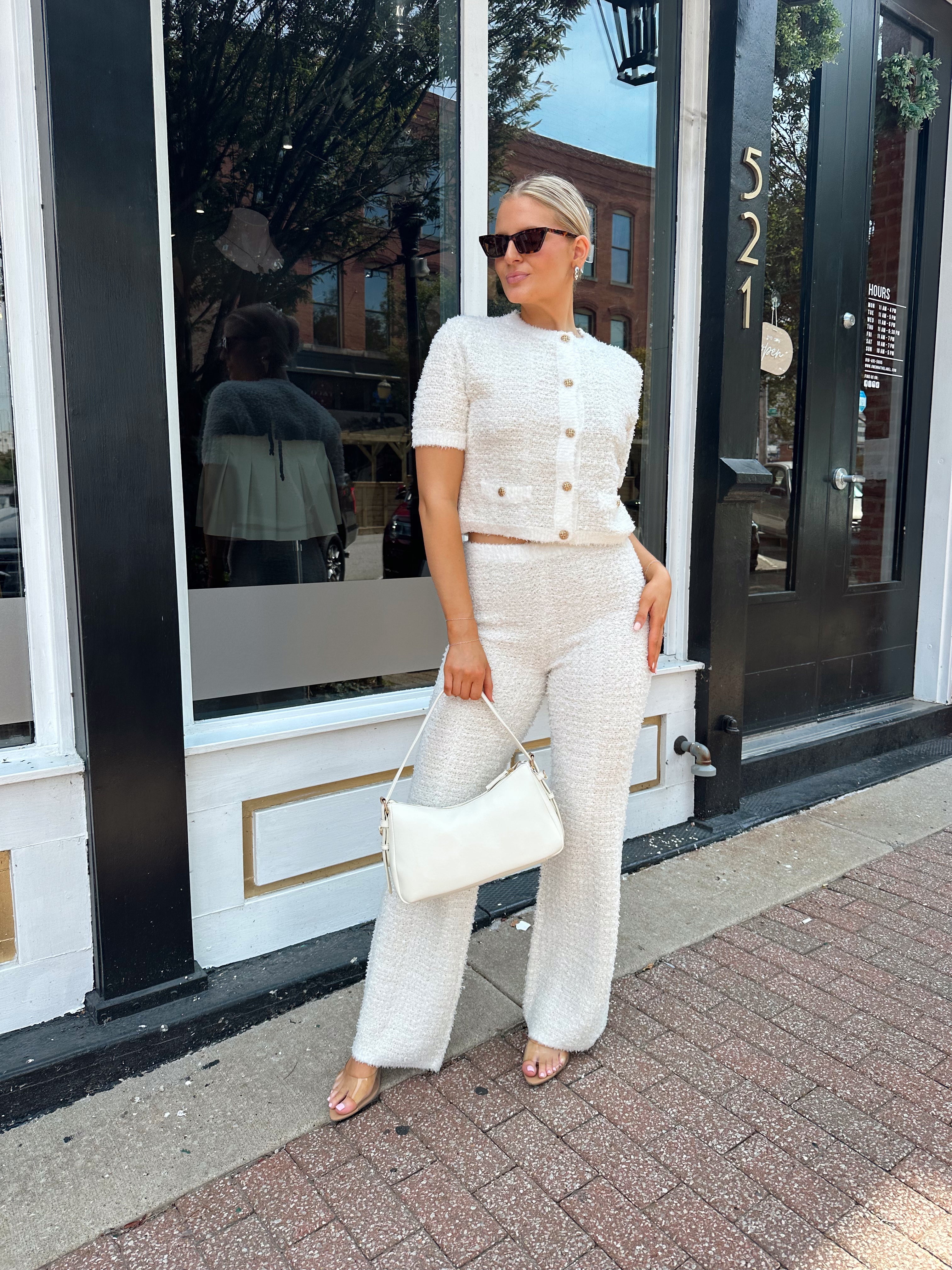 Ivory bouclé two piece set with gold button closure and wide leg pant. 