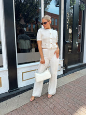 Ivory bouclé two piece set with gold button closure and wide leg pant. 