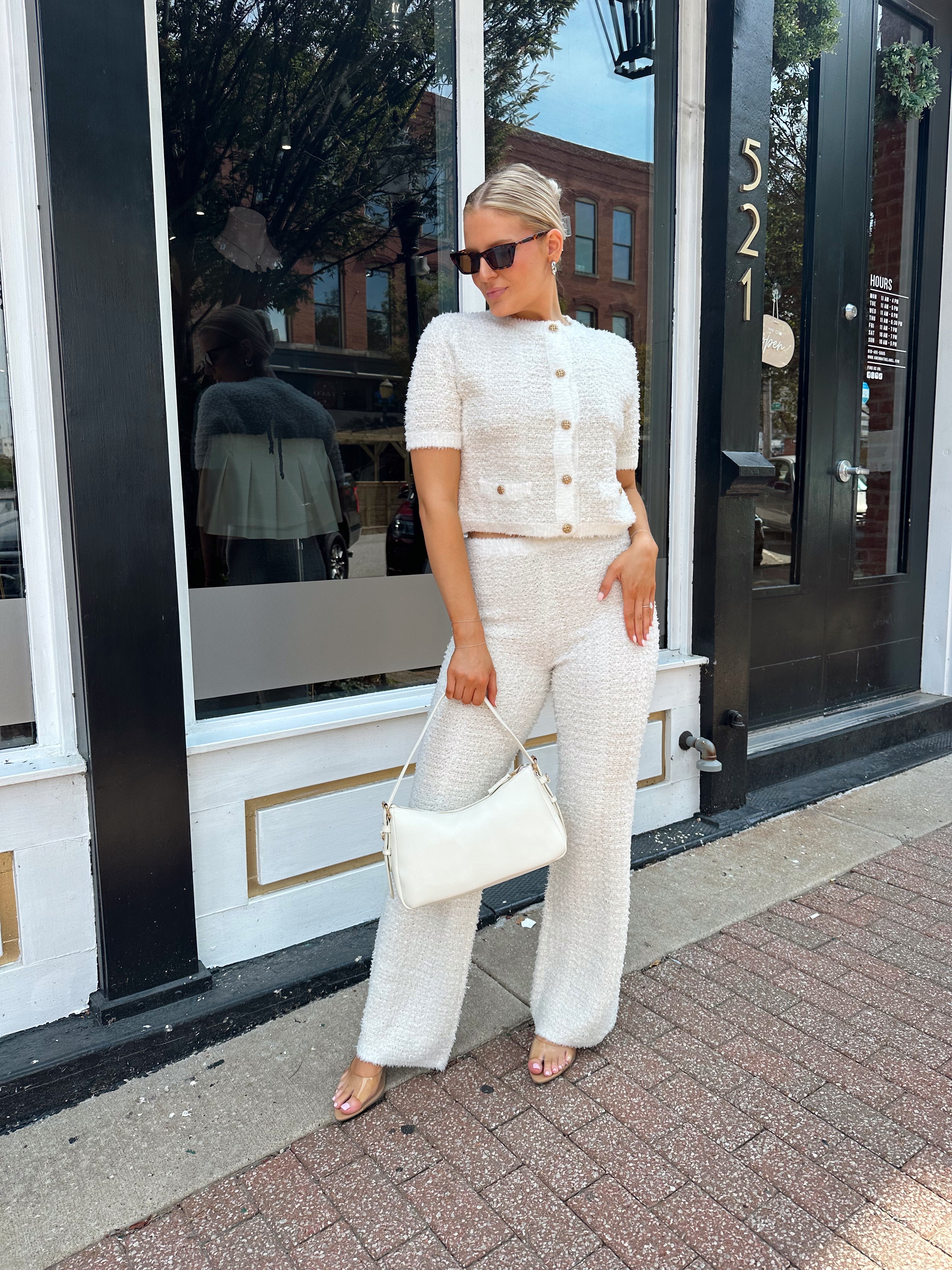 Ivory bouclé two piece set with gold button closure and wide leg pant. 