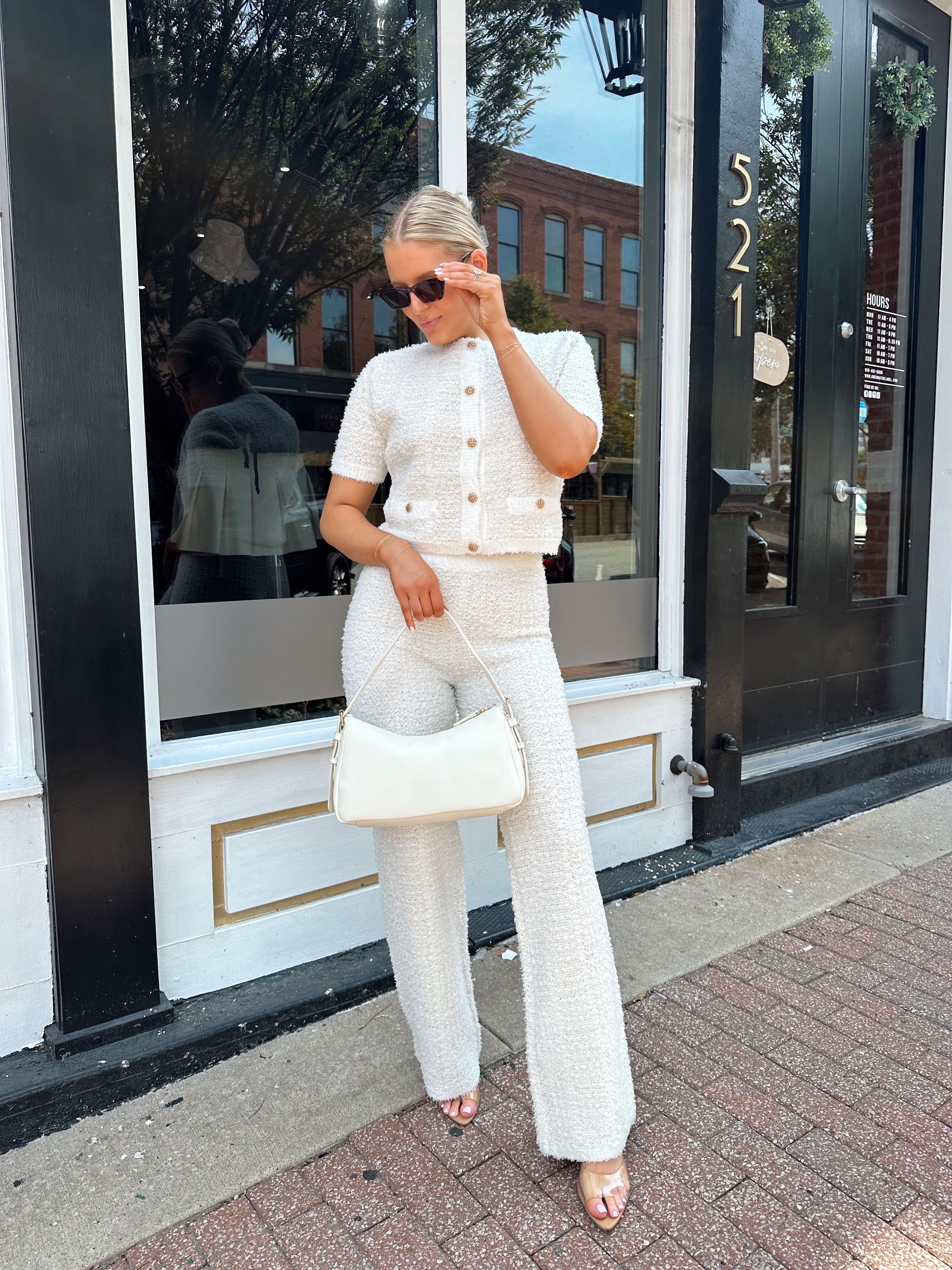 Ivory bouclé two piece set with gold button closure and wide leg pant. 