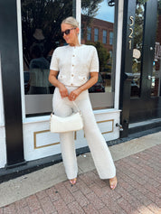 Ivory bouclé two piece set with gold button closure and wide leg pant. 