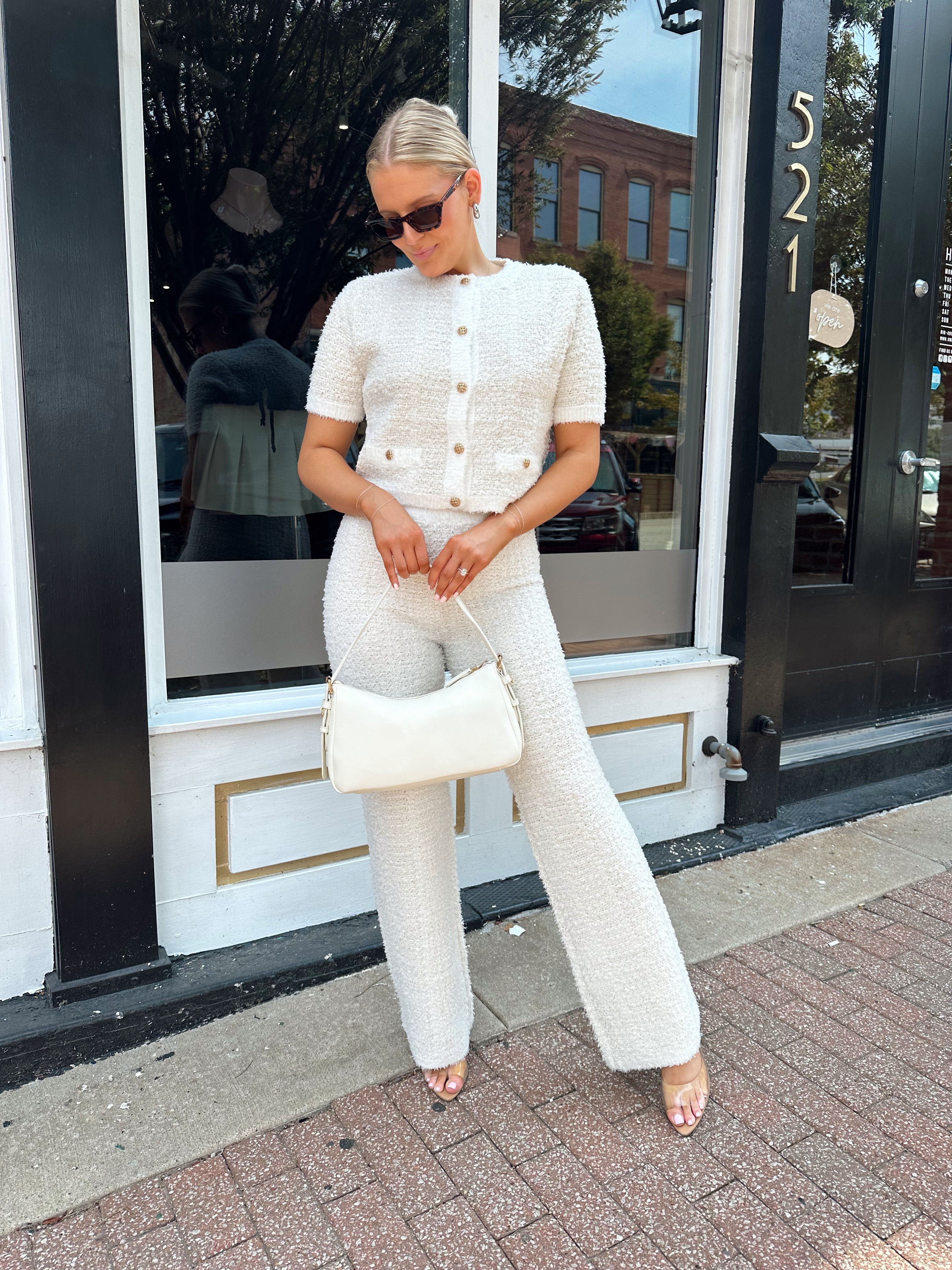 Ivory bouclé two piece set with gold button closure and wide leg pant. 
