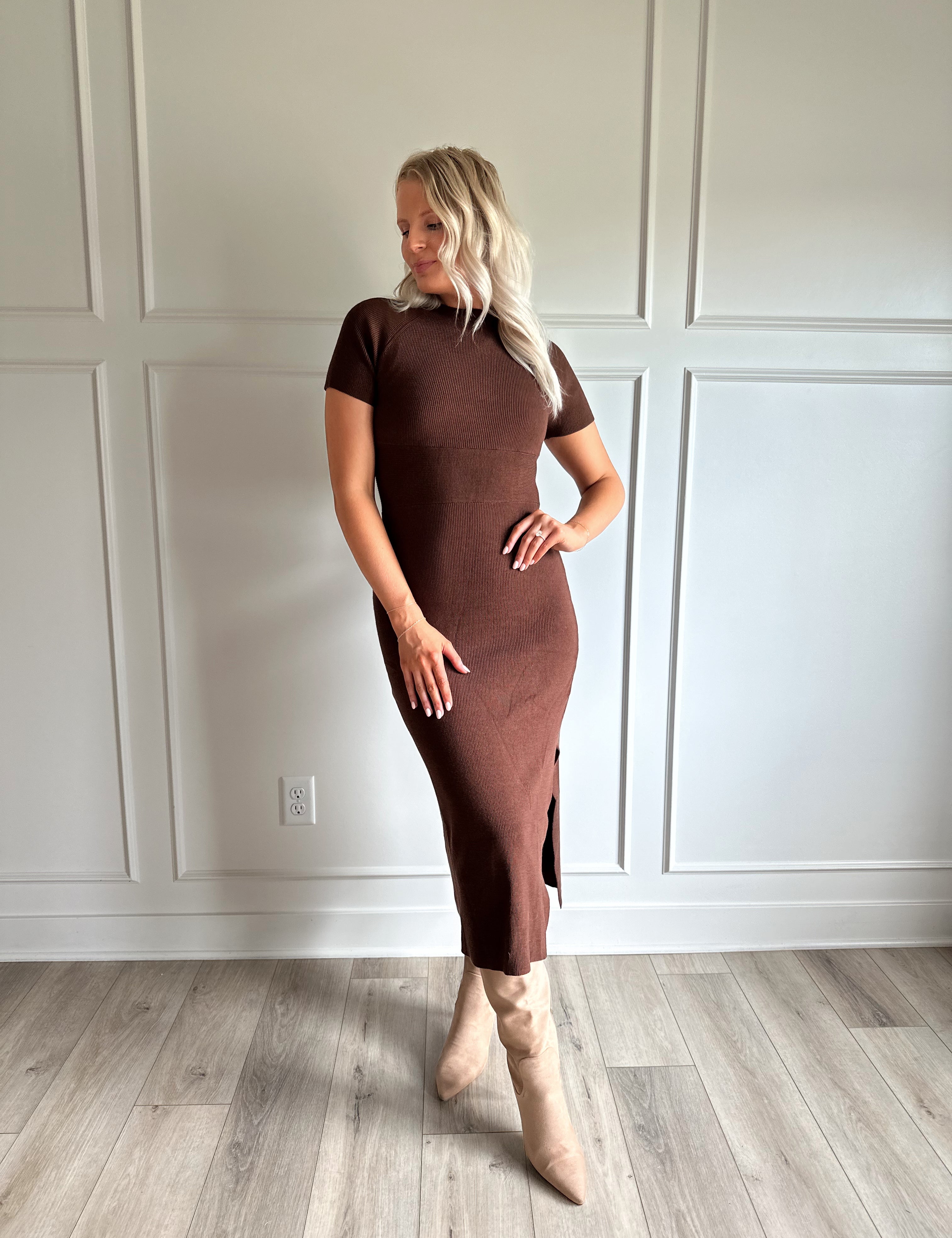 Woman wearing brown ribbed short sleeve midi dress with cutout back and tie detail.