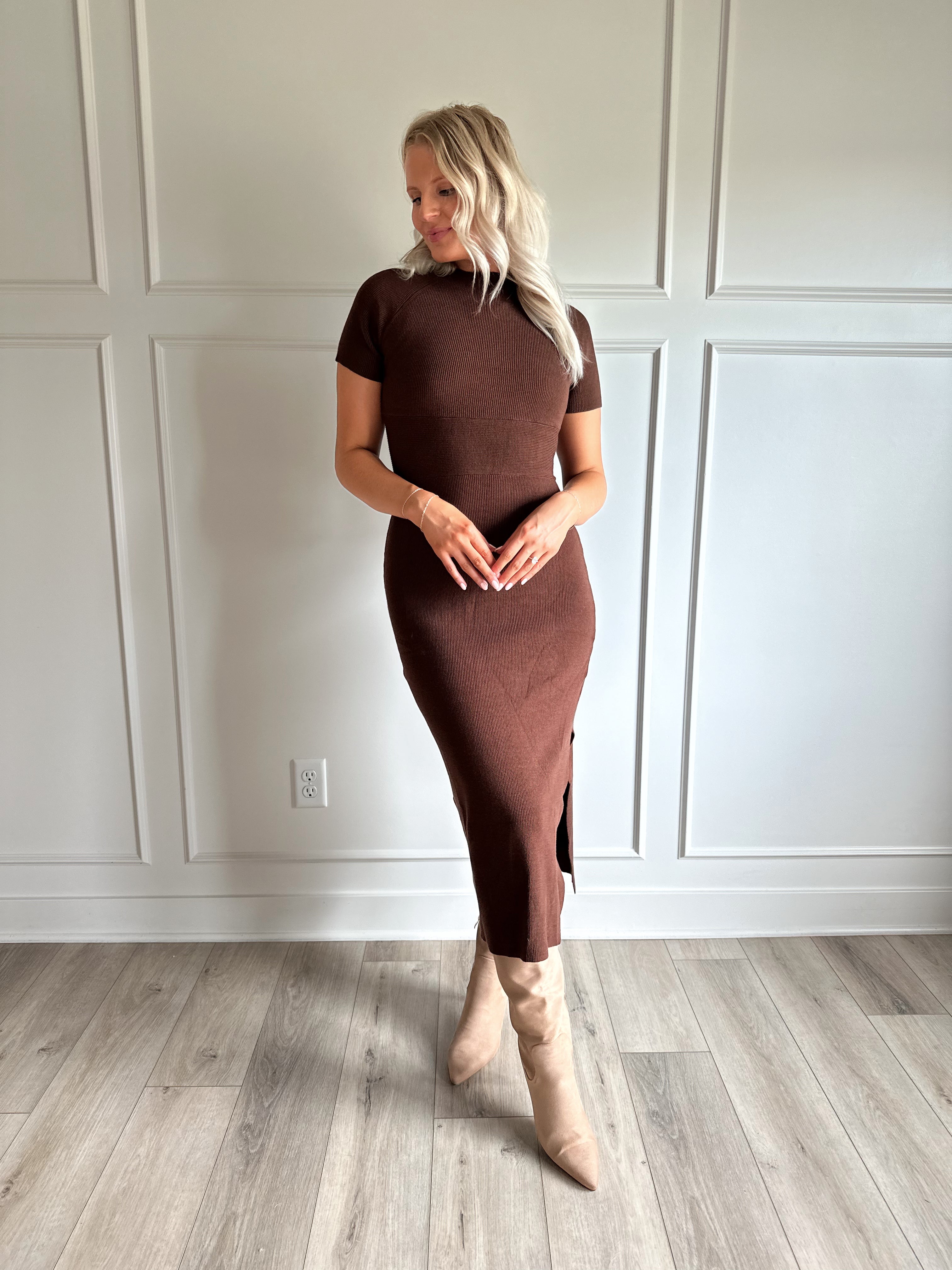Woman wearing brown ribbed short sleeve midi dress with cutout back and tie detail.
