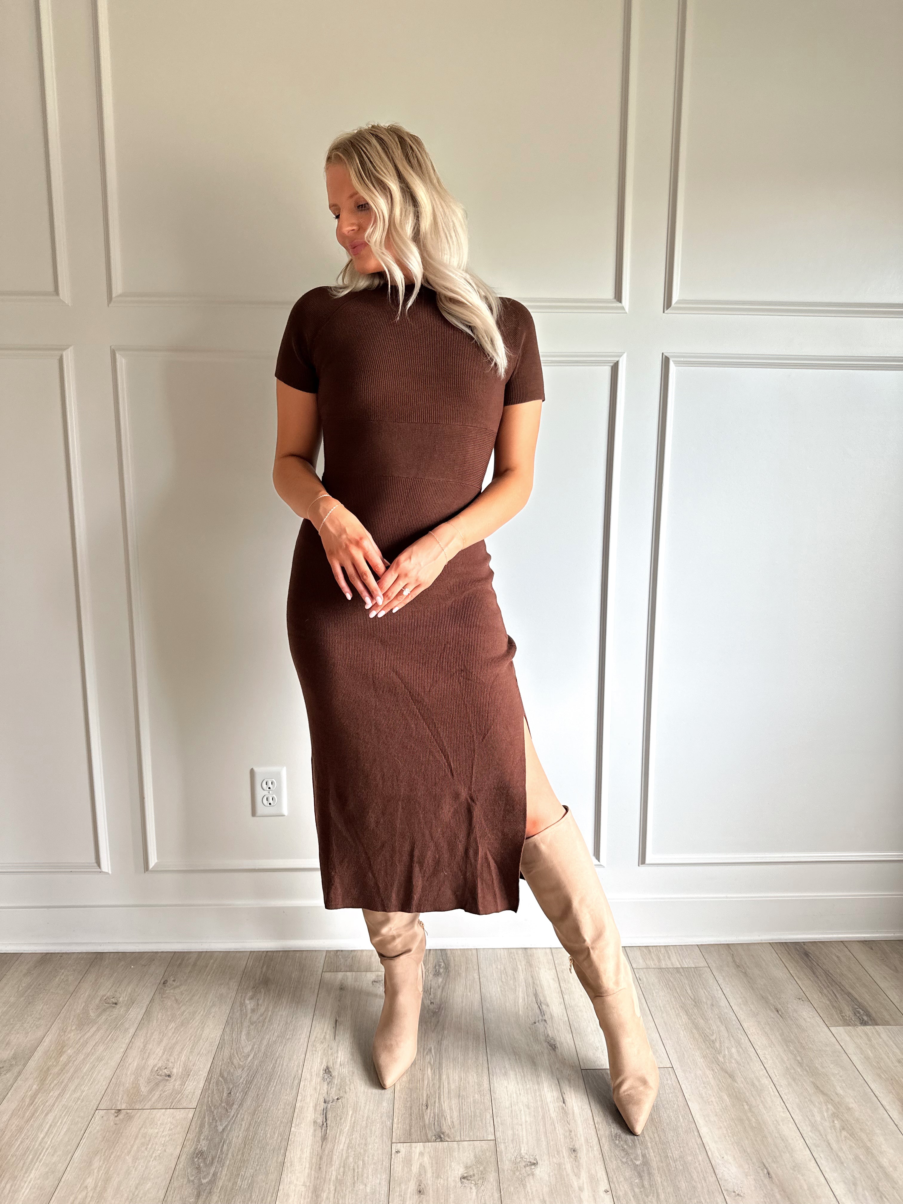 Woman wearing brown ribbed short sleeve midi dress with cutout back and tie detail.
