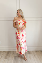 Model wearing off-the-shoulder floral midi dress with pink and red watercolor print